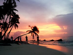 On the beach, white sand, sun-loungers, beach umbrellas