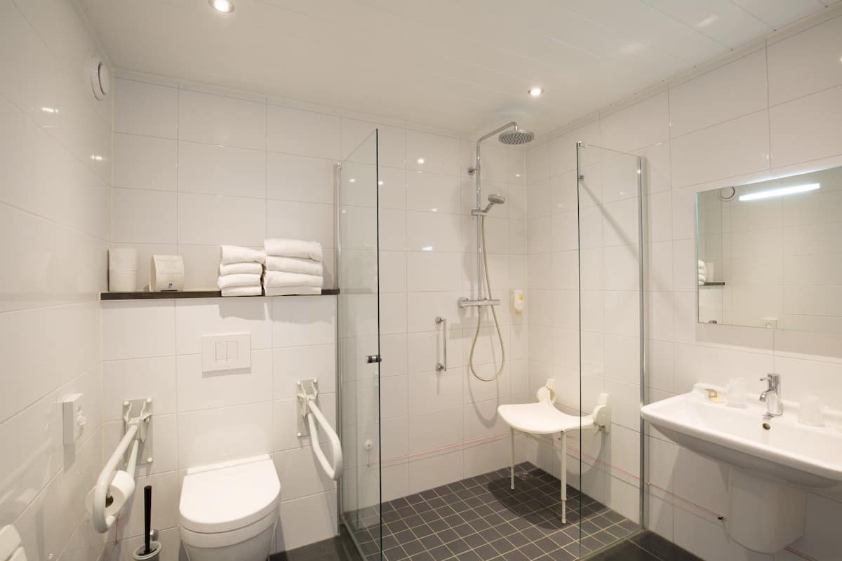 family room | bathroom | shower, rainfall showerhead, hair dryer, towels
