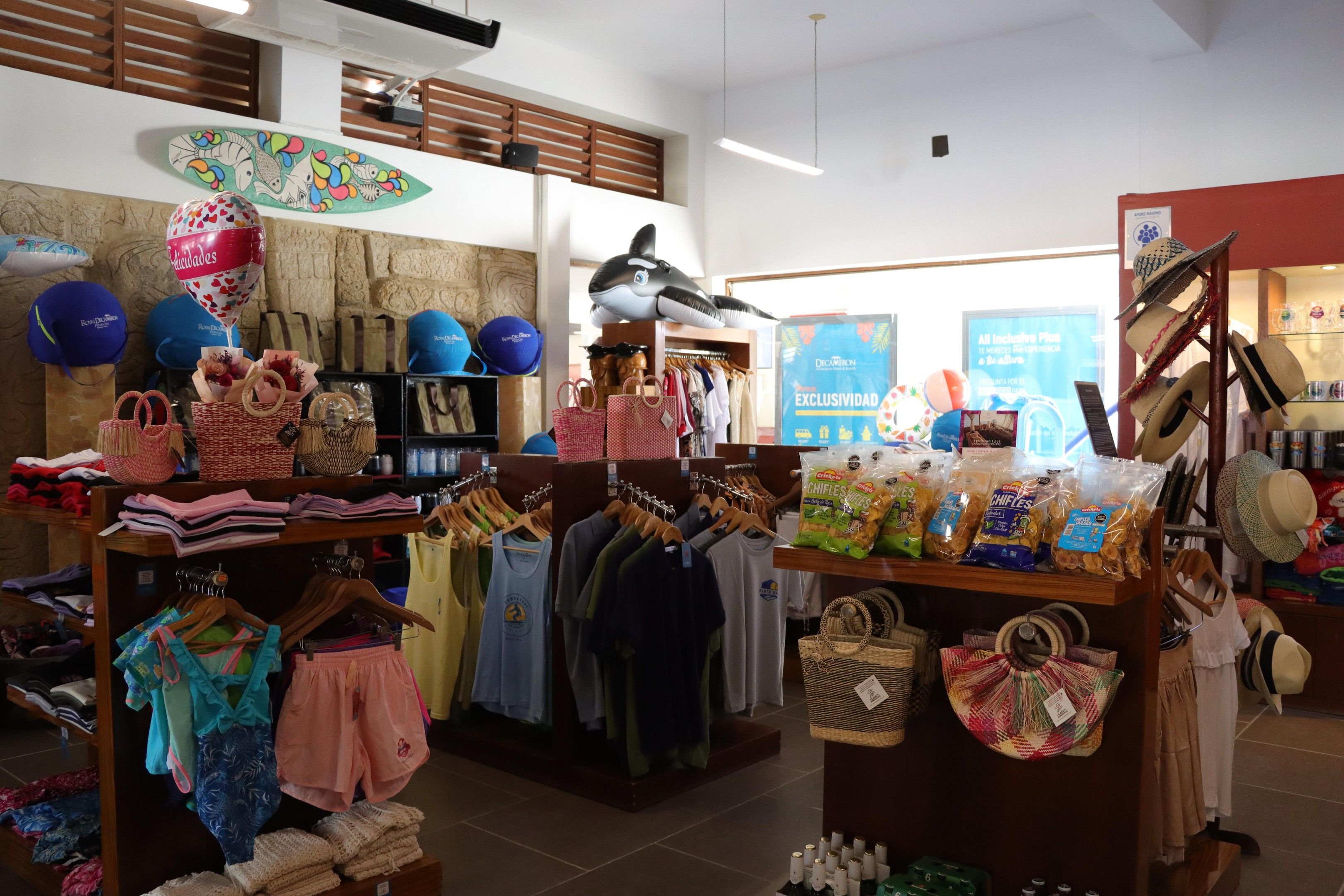 A retail store with various clothing items, accessories, and bags on display.