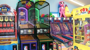 A variety of arcade games including basketball and racing games, with colorful designs and interactive elements. - Cape Cod Family Resort and Parks (West Yarmouth)