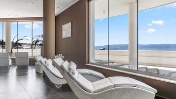 Relax in a comfortable lounge area with reclining chairs and ocean views.