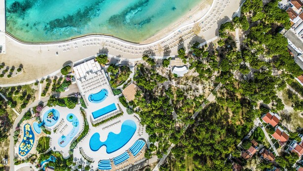 An aerial view of a resort with a beach, swimming pools, and a landscaped area. - Zaton Holiday Resort Apartments (Nin)