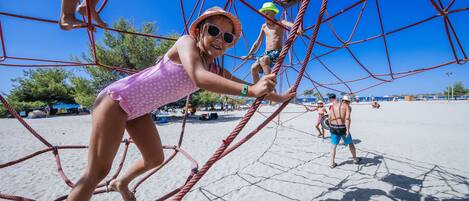 A beach scene with a rope net structure.