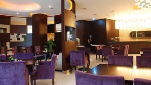 A modern hotel lobby with purple seating, a reception desk, and a large chandelier. - City Inn Happy Valley Chengdu (Chengdu)