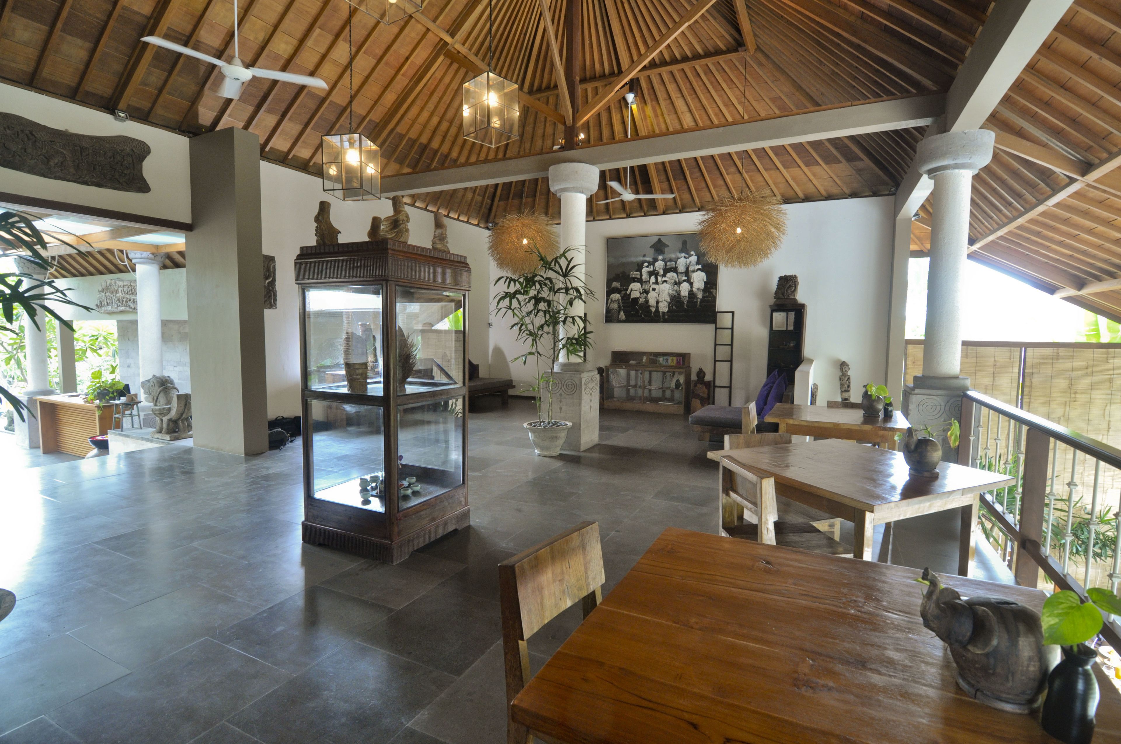 A spacious indoor area with a high ceiling, wooden beams, and a glass display case.
