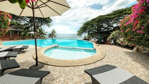 Outdoor pool, an infinity pool, pool umbrellas, sun loungers