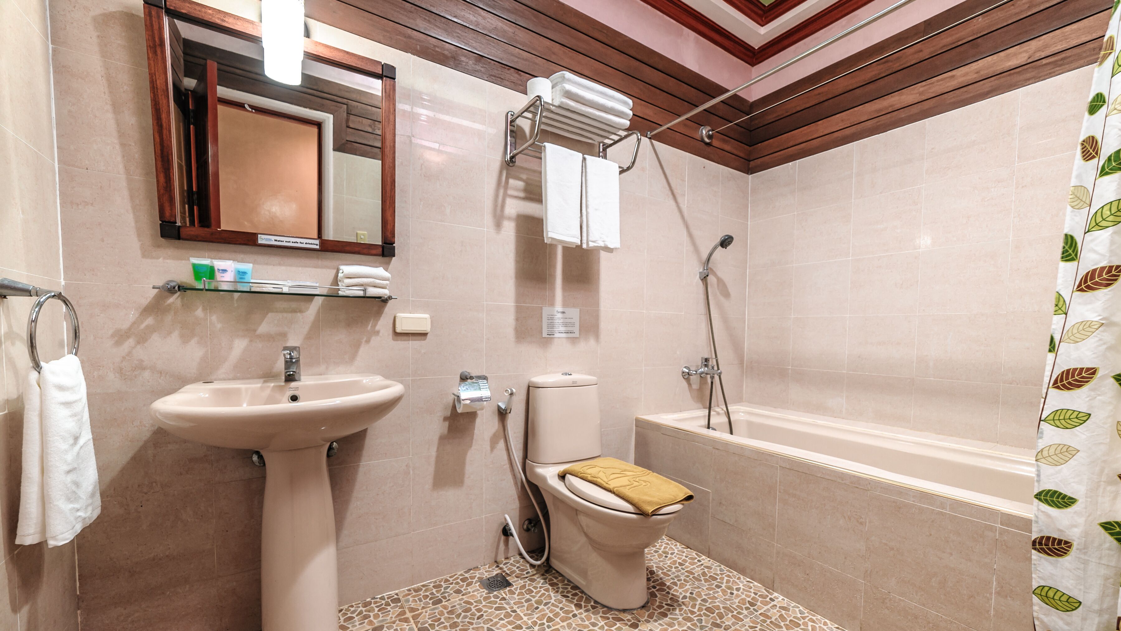 A bathroom with a sink, toilet, and bathtub.