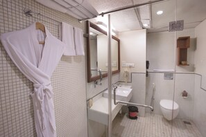 A bathroom with a glass shower enclosure, a white sink, and a toilet. - The HQ (Vasco da Gama)