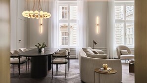 A modern interior with a dining area, seating, and large windows. - The Ritz-Carlton, Vienna (Vienna)