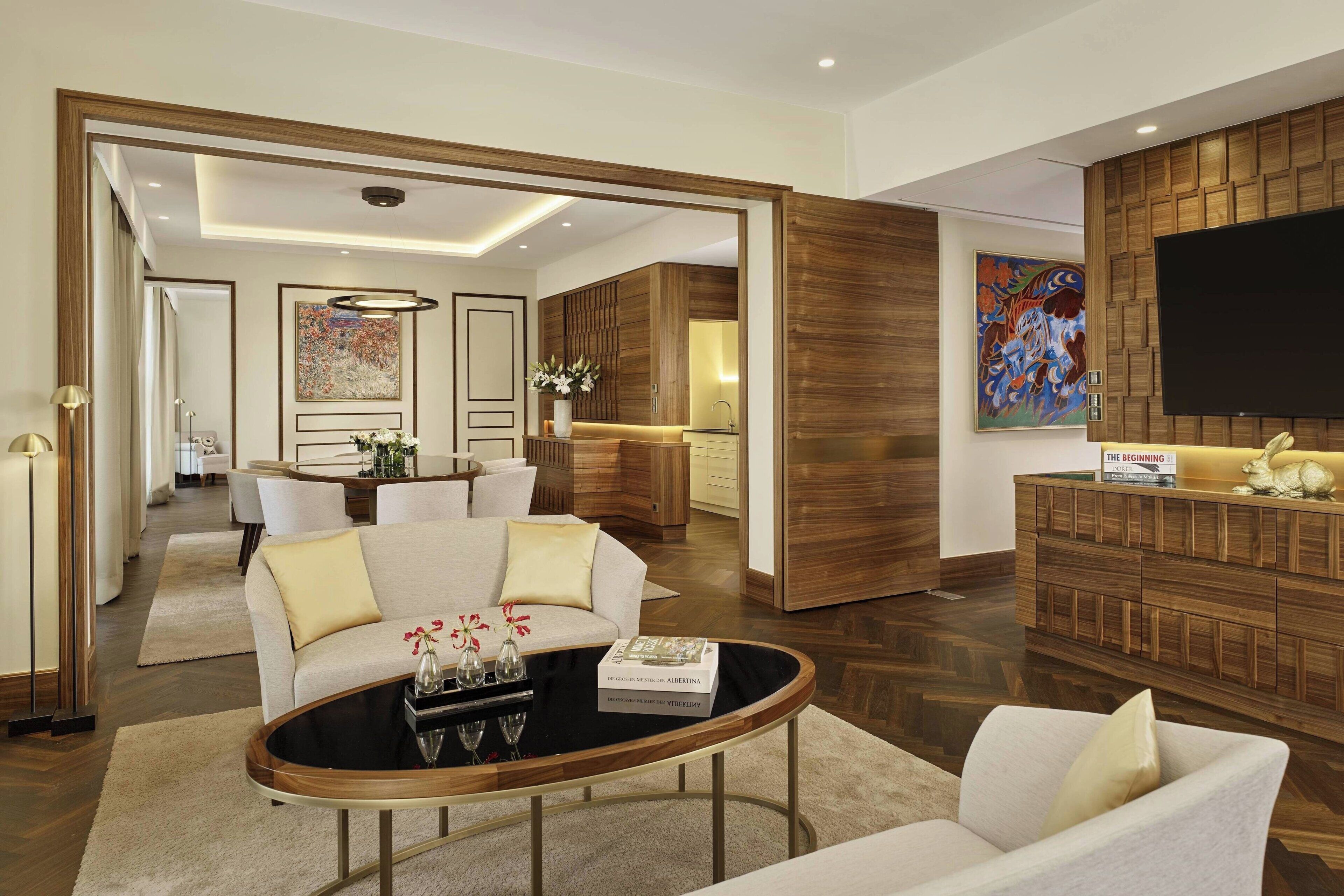 A modern living room with a sofa, coffee table, and a flat-screen TV.
