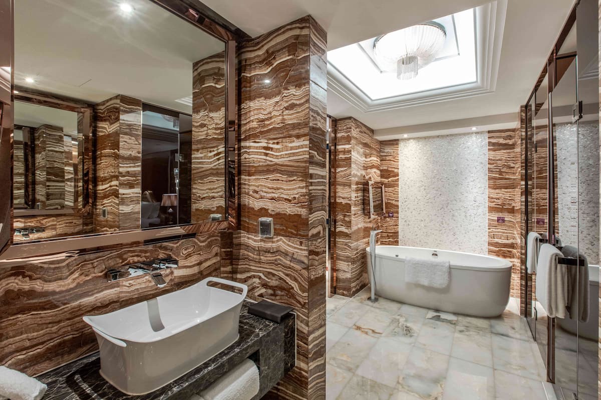 presidential suite, multiple beds | bathroom | rainfall showerhead, free toiletries, hair dryer, bathrobes