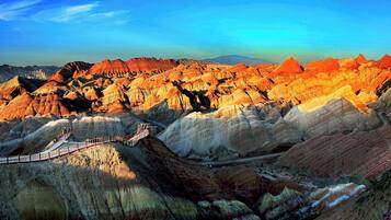 A scenic landscape with a winding road and a bridge.