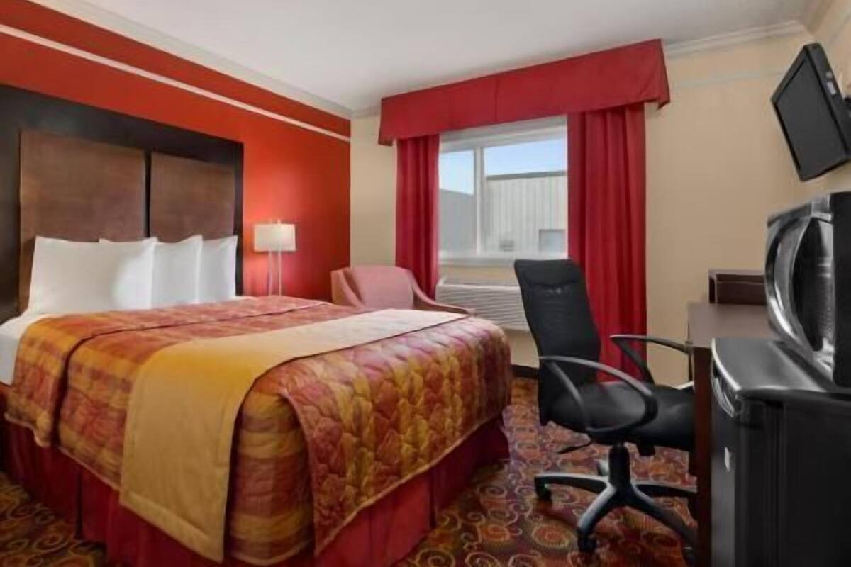 Desk, laptop workspace, blackout drapes, iron/ironing board