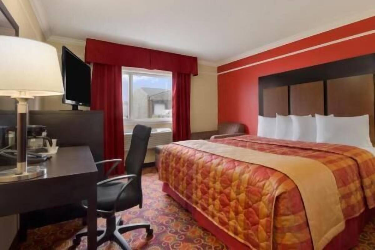 Desk, laptop workspace, blackout drapes, iron/ironing board