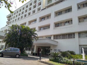 A multi-story building with a flat facade, large windows, and a central entrance.