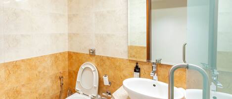 A modern bathroom with a toilet, sink, and mirror.