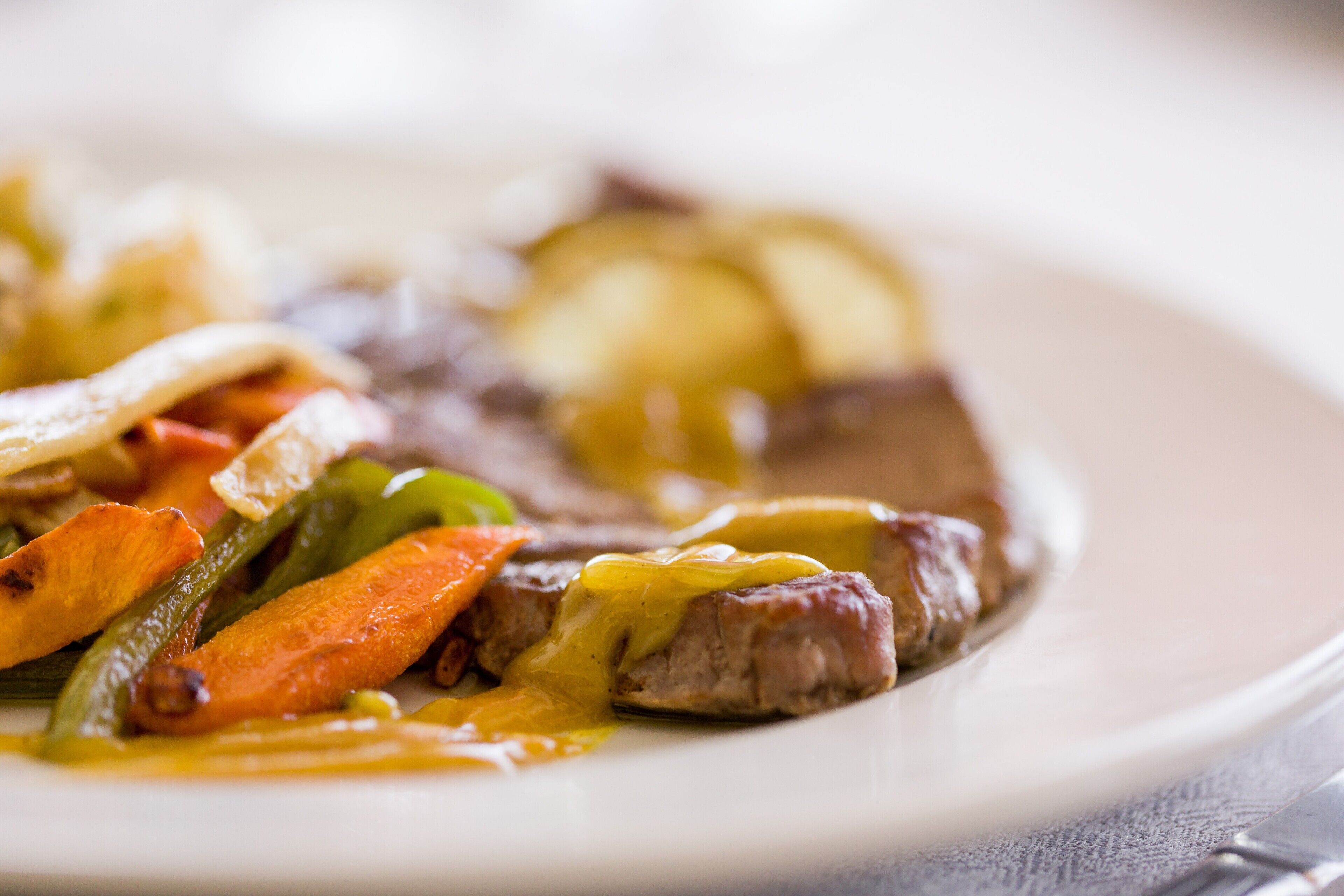 A plate of food with meat and vegetables.