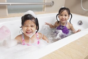 Relax in a clean and well-maintained bathtub with a shower facility.