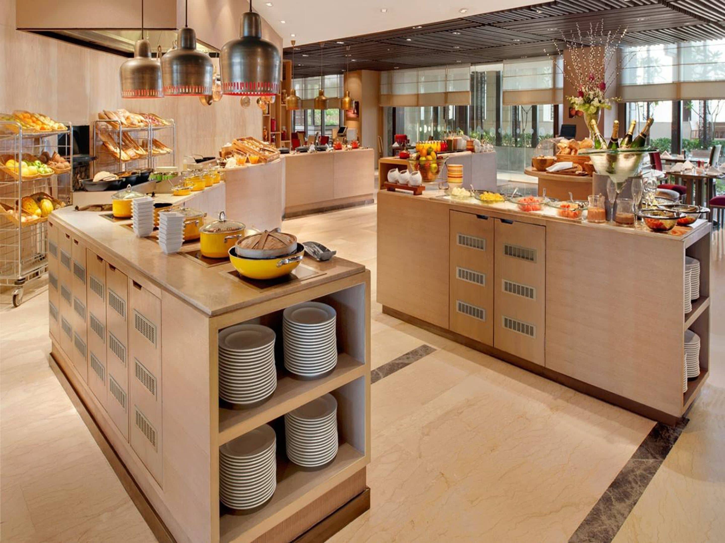 A buffet setup with various food items and a large central island.