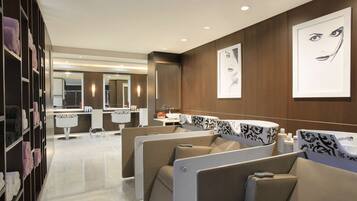 Relax in a serene space with a central sink area, two sinks, and comfortable seating areas with privacy partitions.