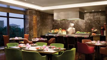 A restaurant with a high ceiling, modern decor, and a view of the cityscape.