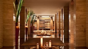 A hallway with a central water feature, flanked by tall columns and potted plants. - The Leela Ambience Convention Hotel Delhi  (New Delhi)