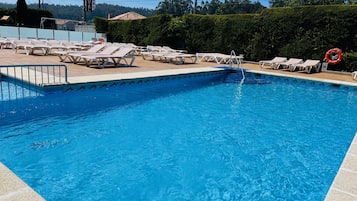 Seasonal outdoor pool, open 10:30 AM to 9 PM, pool umbrellas