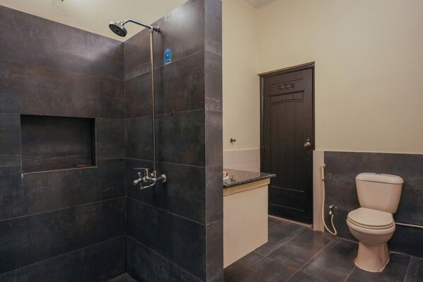 A bathroom with a shower, toilet, and sink.