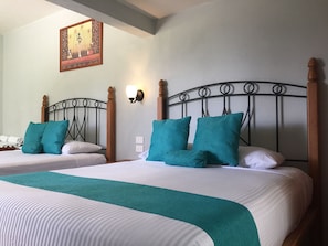 Standard Quadruple Room, 2 Queen Beds | Desk, laptop workspace, blackout drapes, bed sheets - Hotel RV Park San Ramon (San Miguel de Allende)