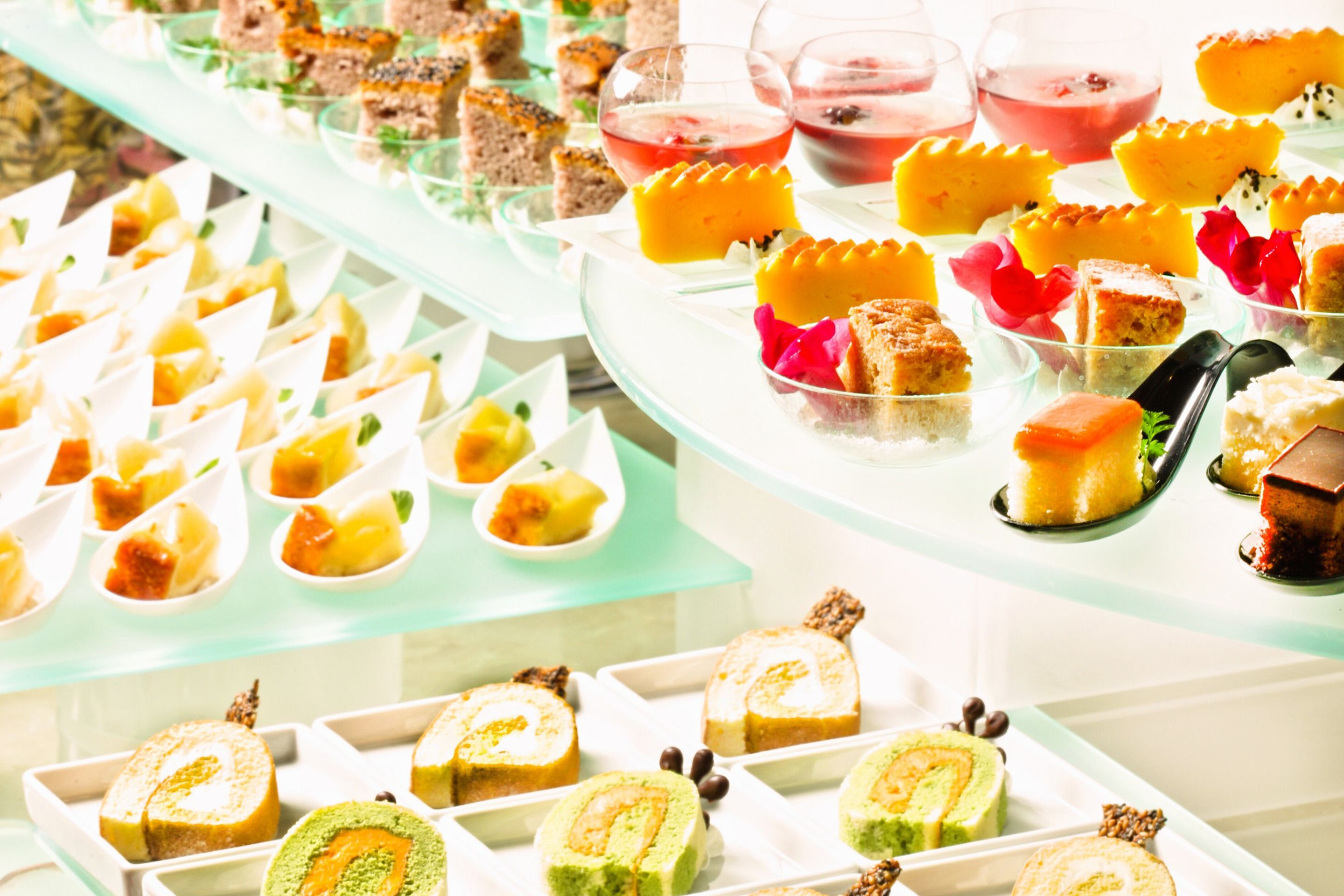 A buffet with various desserts and beverages.