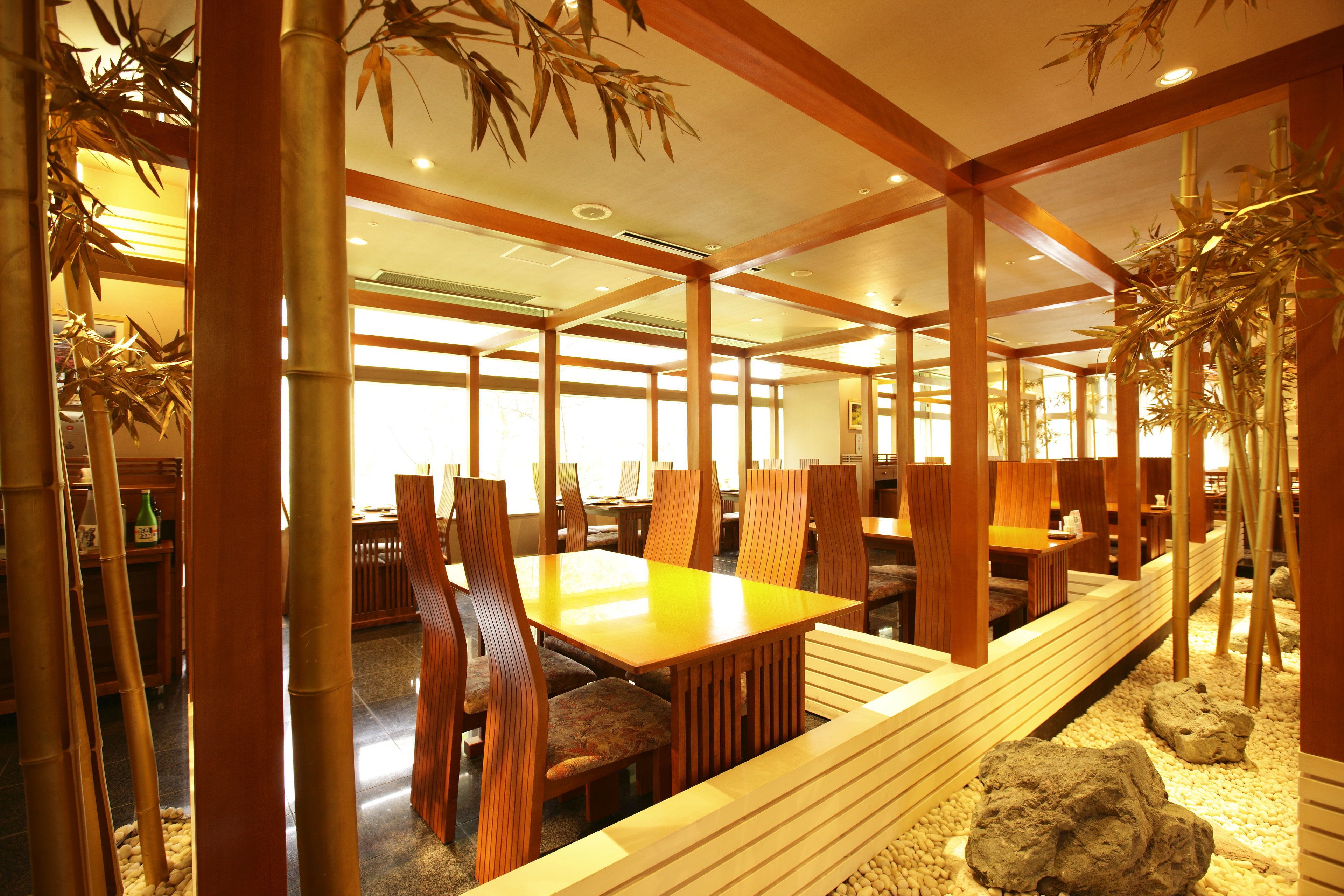 A traditional Japanese-style room with wooden furniture, tatami mats, and bamboo decorations.