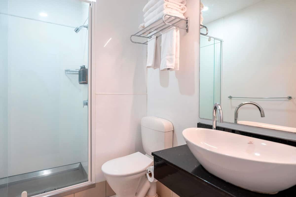 Desk, laptop workspace, iron/ironing board, travel cot