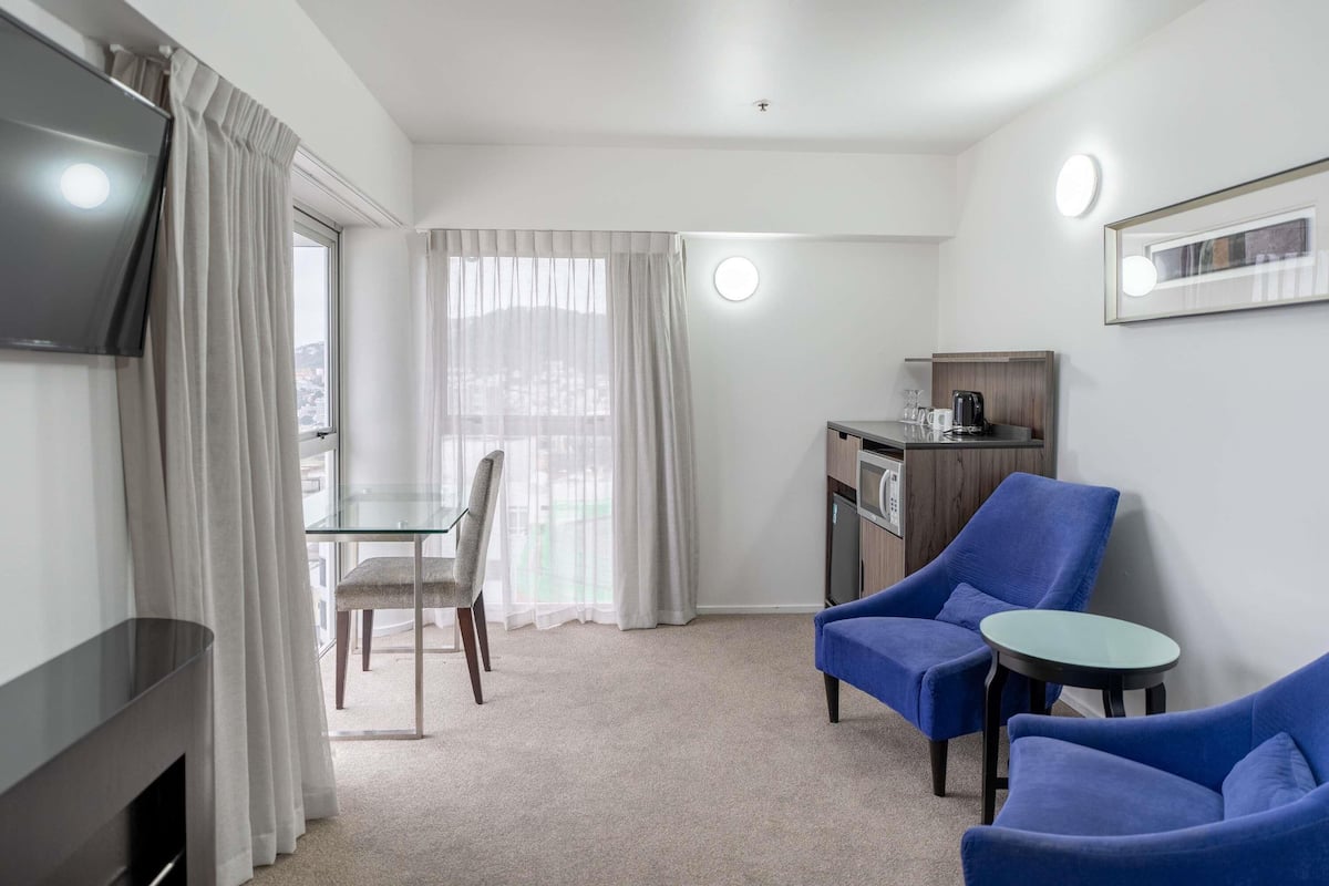 Desk, laptop workspace, iron/ironing board, travel cot