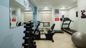 A gym with exercise equipment, a treadmill, and a large exercise ball. - Ginger Mumbai Andheri (MIDC) (Mumbai)