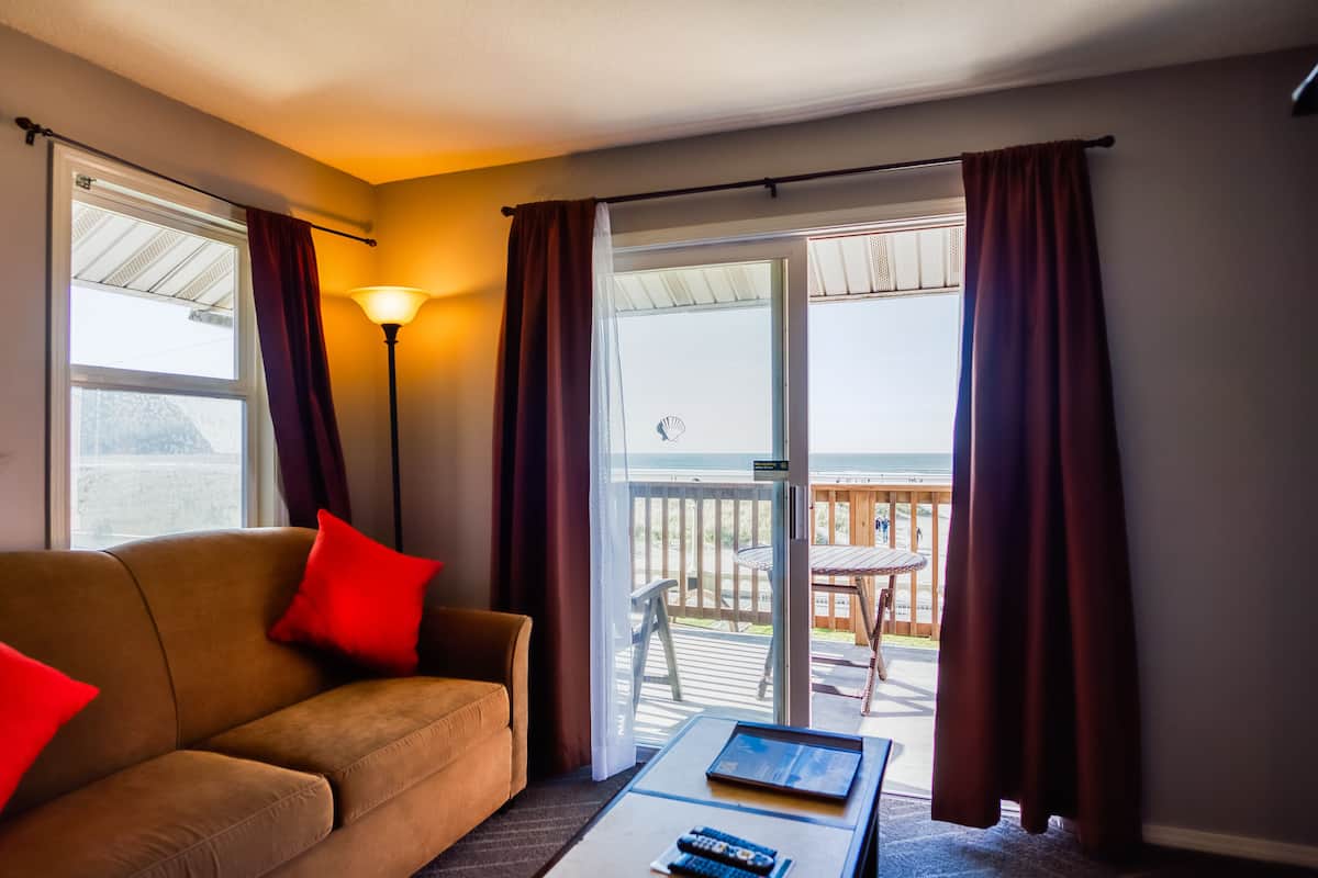 suite, oceanfront king with sofa bed & spa | living area | flat-screen tv, fireplace, dvd player