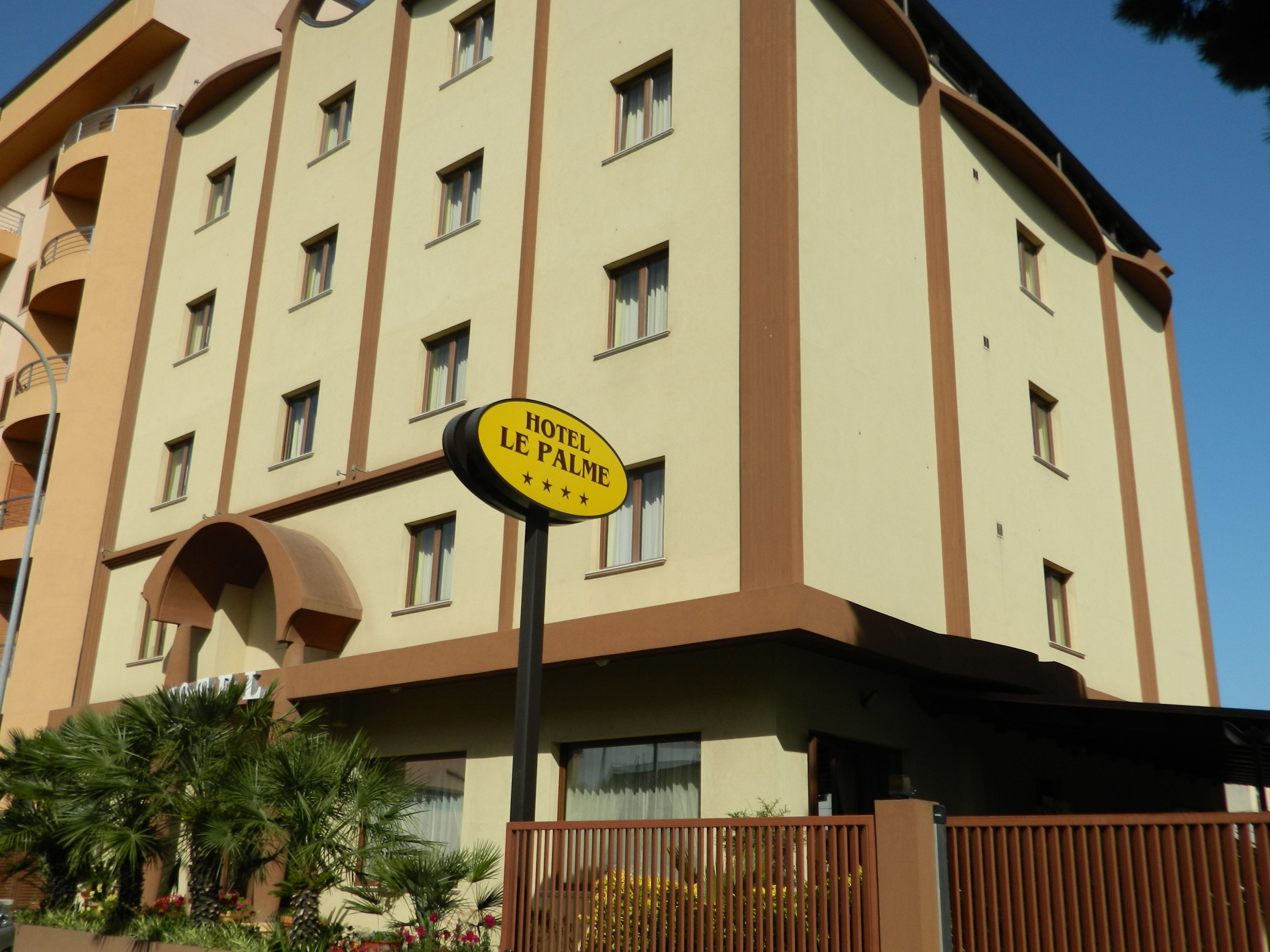 A hotel sign with "HOTEL LE PALME" and four stars.
