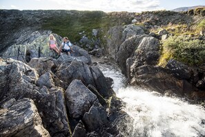 A rocky landscape with a river flowing through it.
