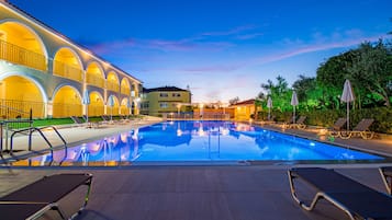 Seasonal outdoor pool, open 9:00 AM to 9:00 PM, pool umbrellas