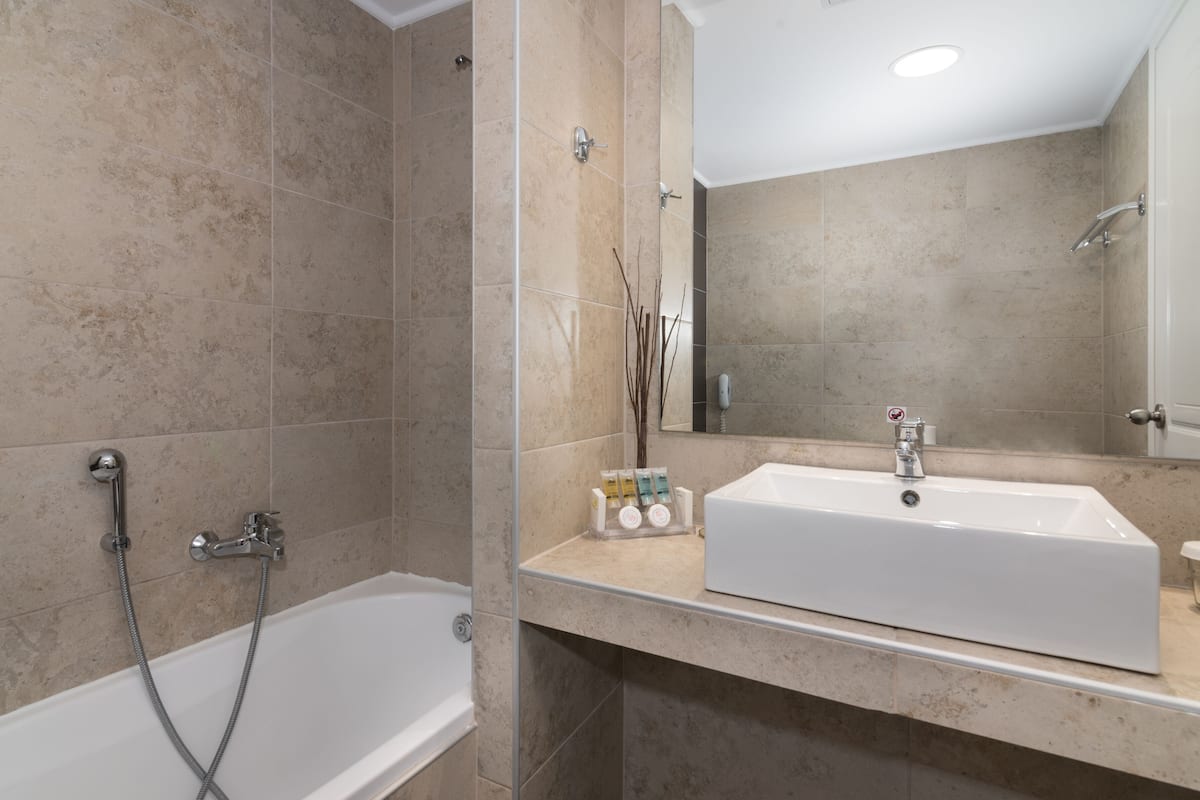 double or twin room, pool view | bathroom | deep-soaking bathtub, free toiletries, hair dryer, towels