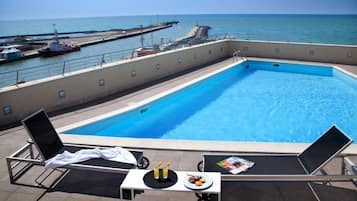 Outdoor pool, open 10:00 AM to 8:00 PM, pool loungers