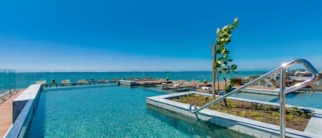 Una piscina al aire libre, tumbonas