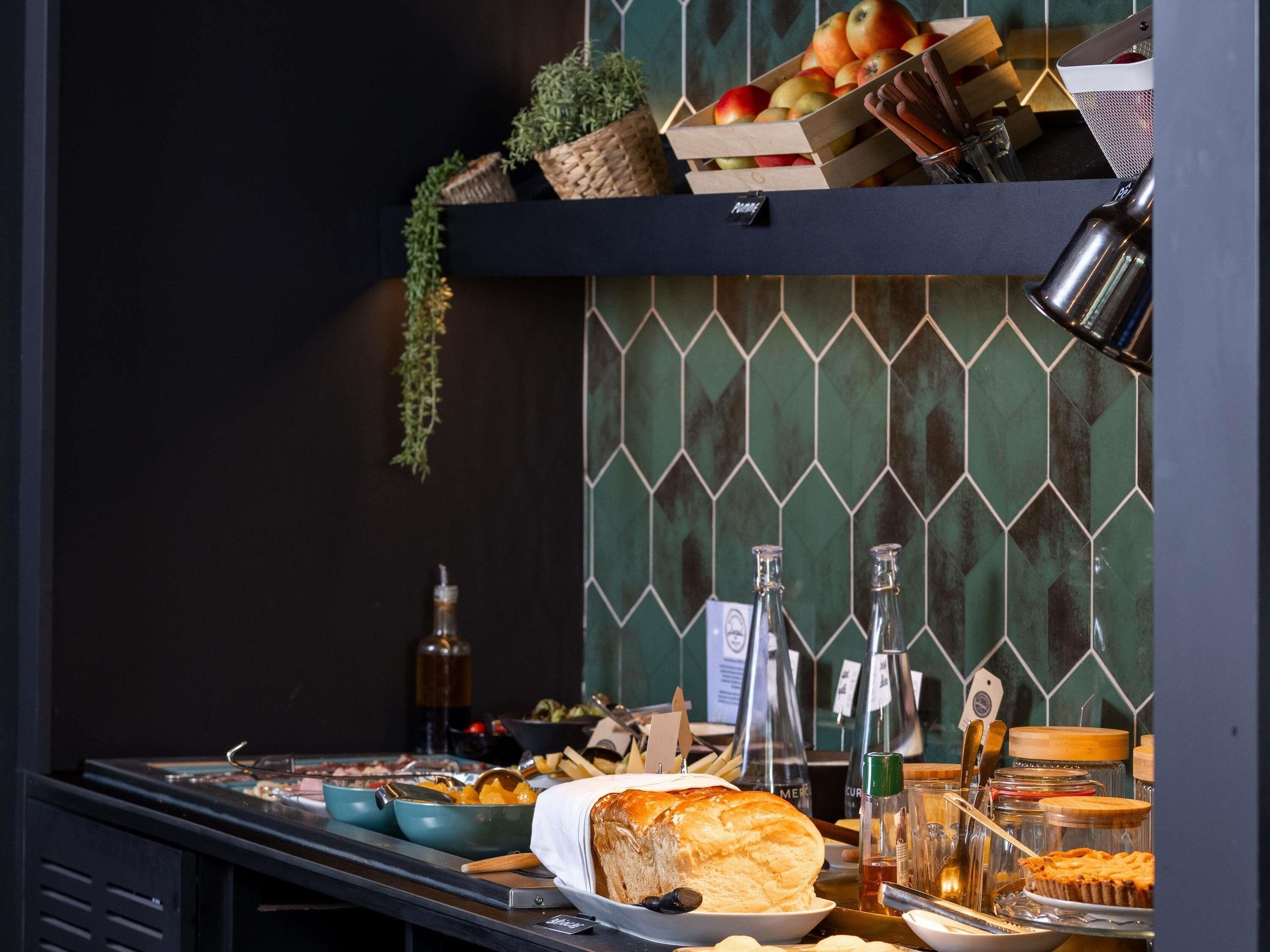 A buffet with various food items, including bread, pies, and fruits.