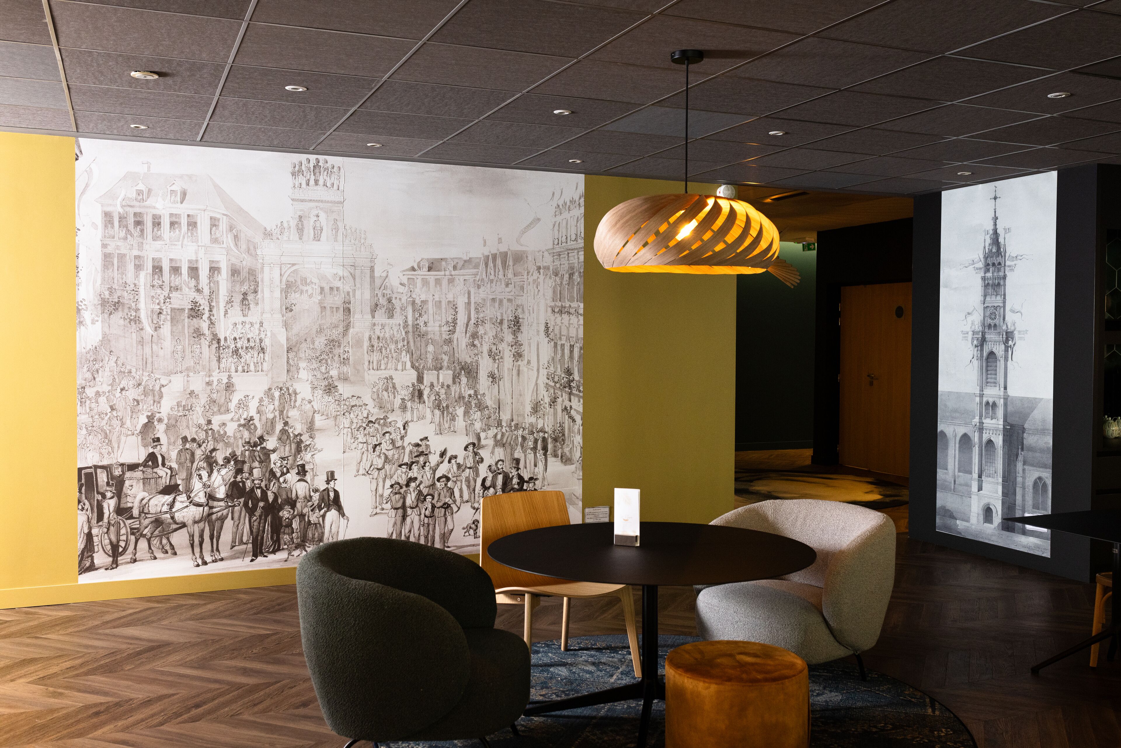 A modern interior with a large mural, a round table, and contemporary seating.
