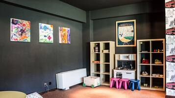 Children can play and learn in this vibrant playroom with a variety of toys and books on display.