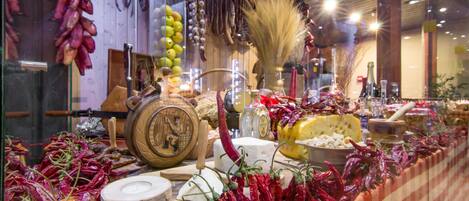 A display of dried fruits, vegetables, and cheeses in a store.