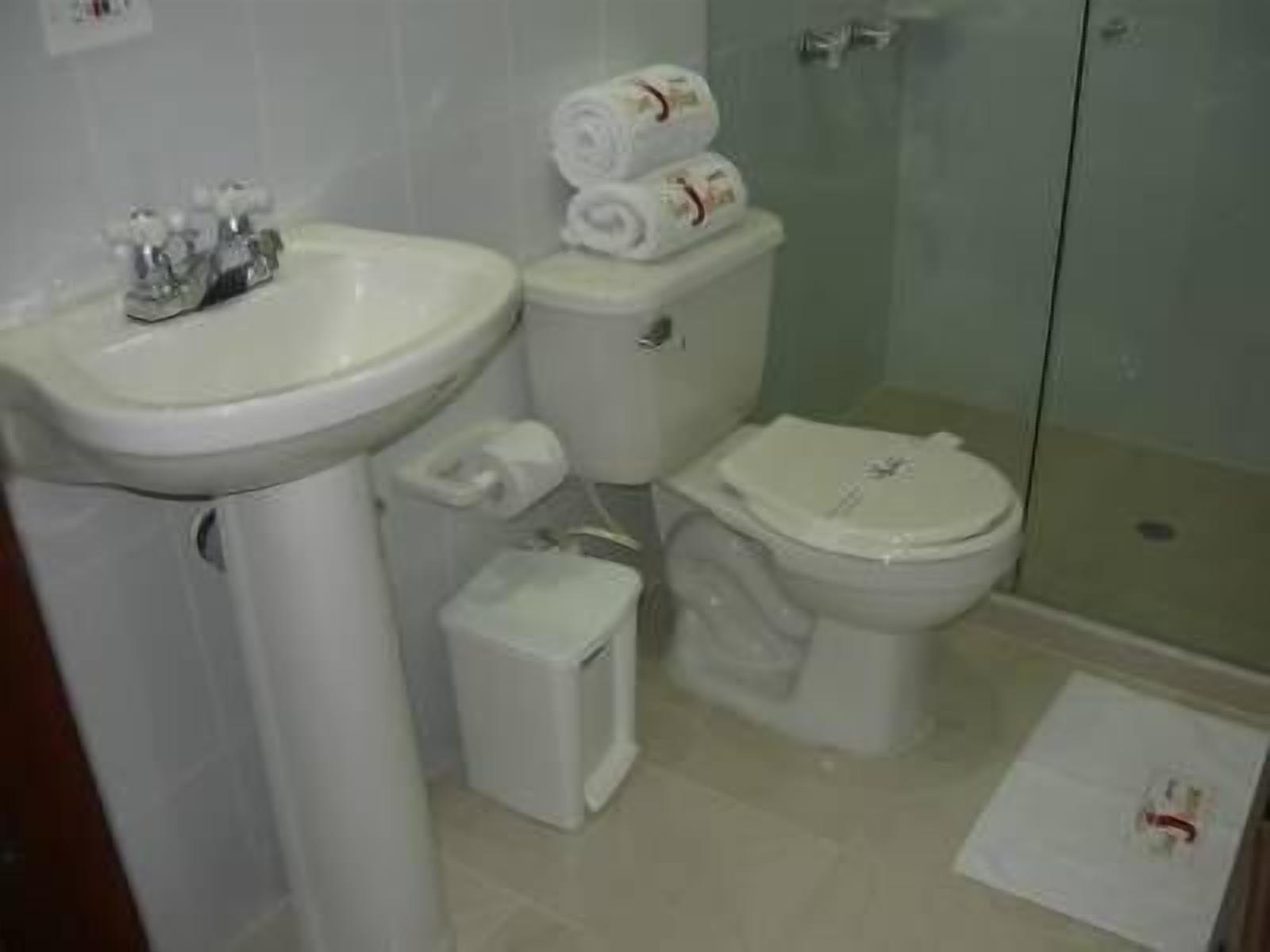 A bathroom with a sink, toilet, and shower.