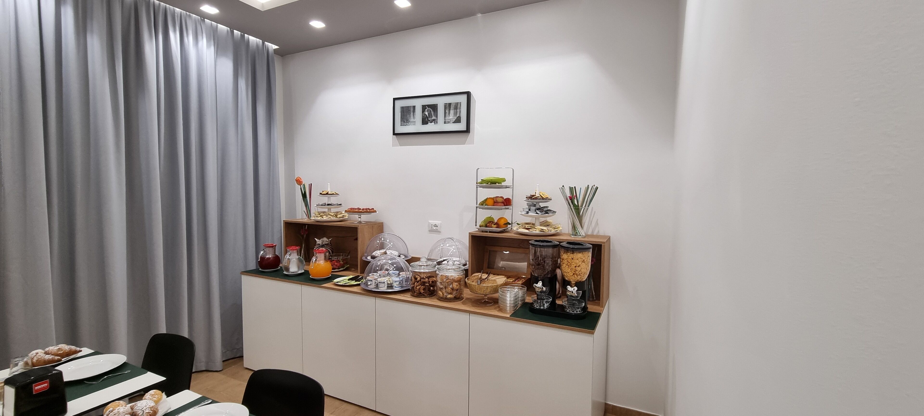 A breakfast bar with various food items and condiments.
