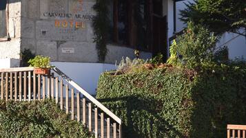 A stone building with a sign reading "Carvalho Araújo Hotel."