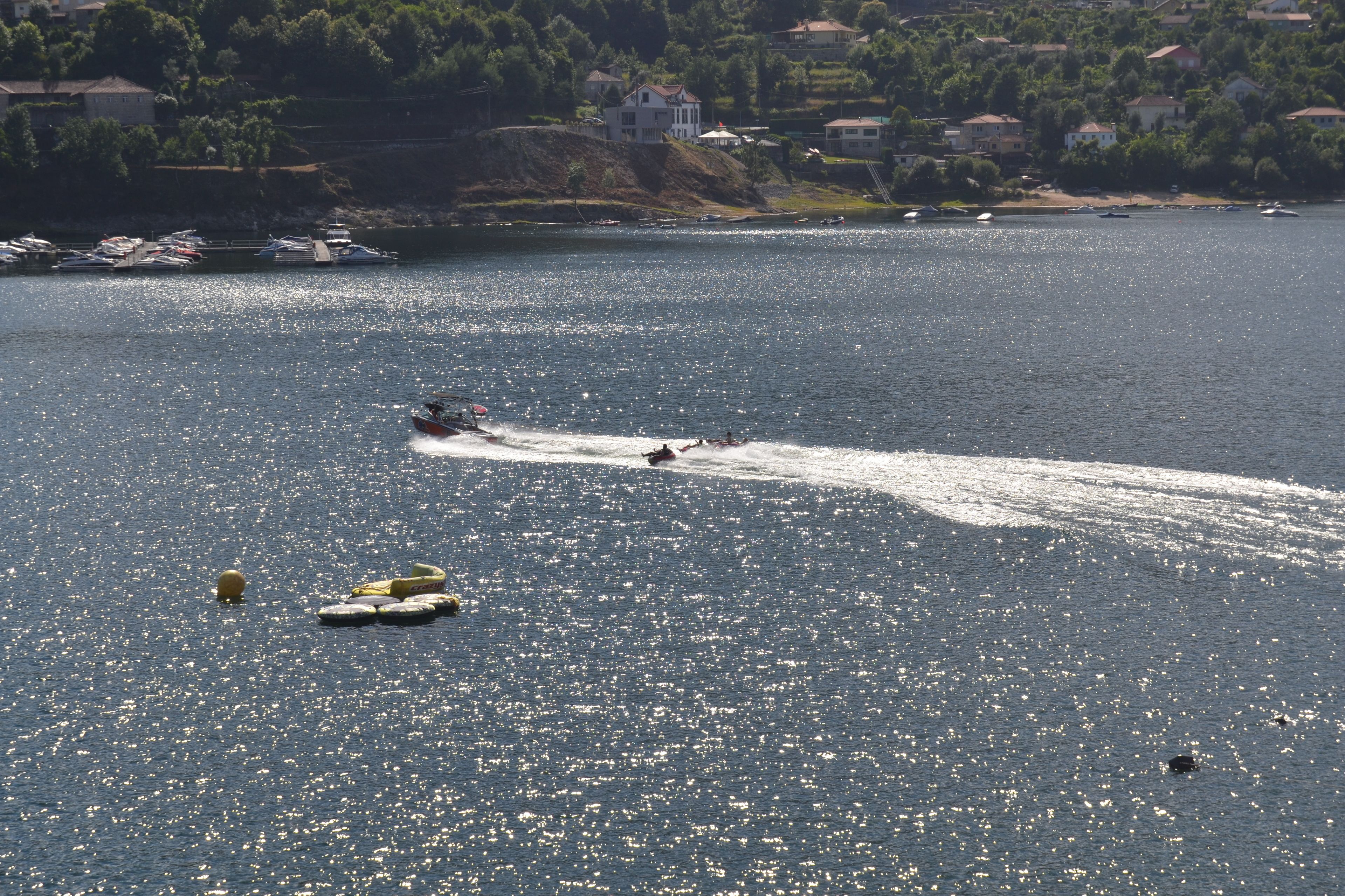 A marina with boats and a jet ski on the water.