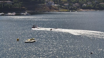 A marina with boats and a jet ski on the water.